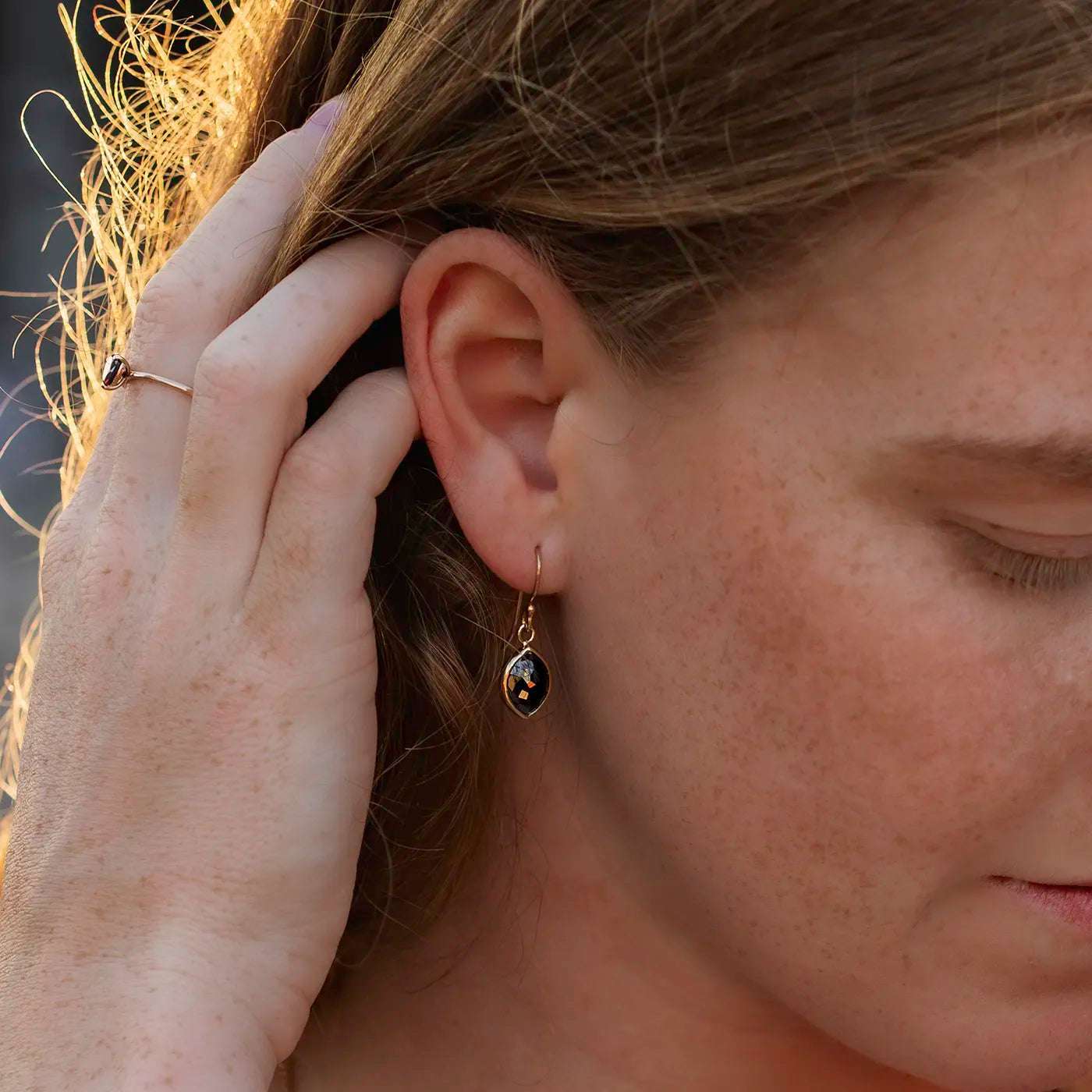 Ohrhaenger schwarzer Diamant Navette 2.0ct an Modelohr nah Sonnenuntergangslicht